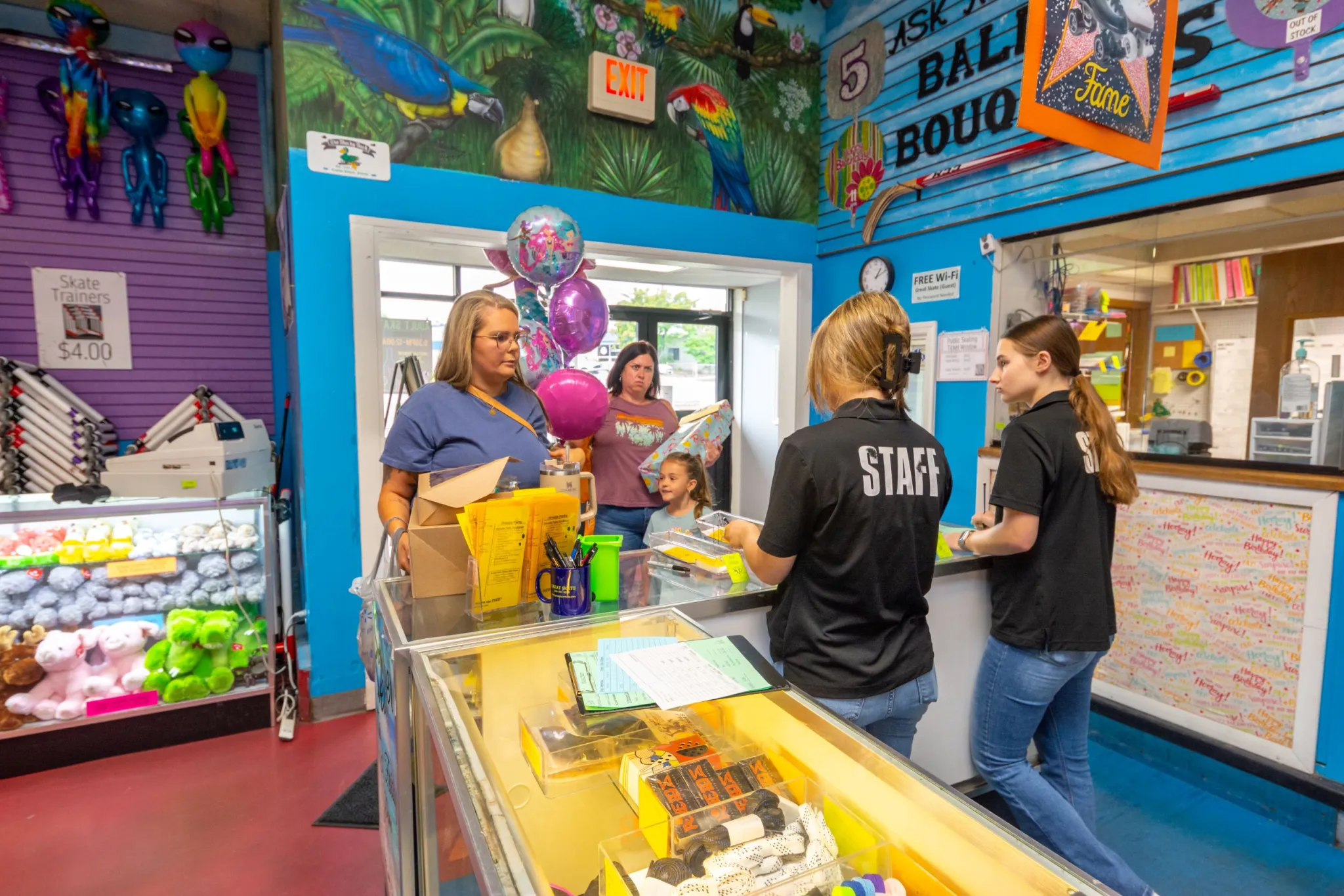Store staff assisting customers with balloons