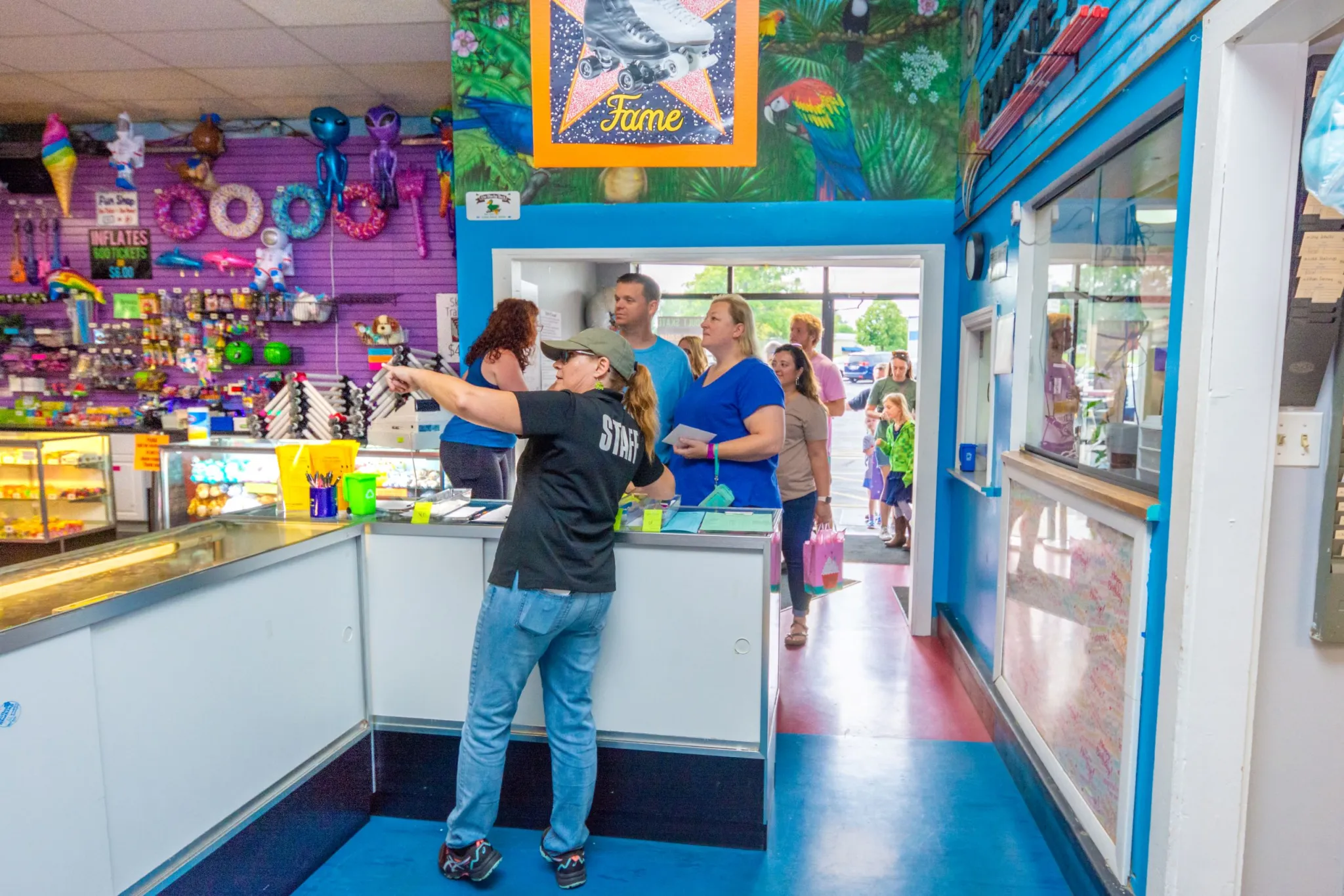 Staff member pointing at arcade counter
